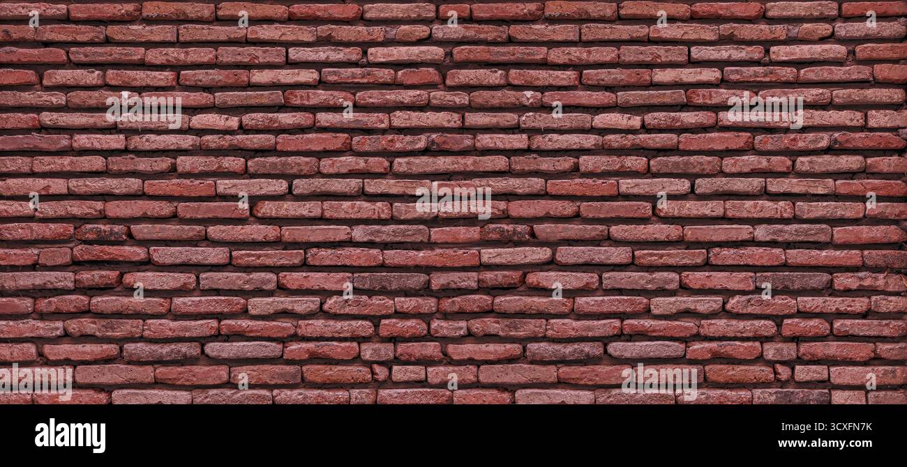Old rustic red brick wall creating structured texture Stock Photo