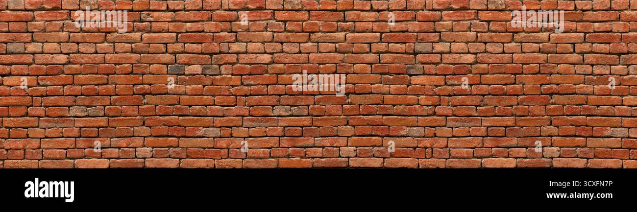 Old red brick wall showing rustic texture and weathered surface with masonry Stock Photo