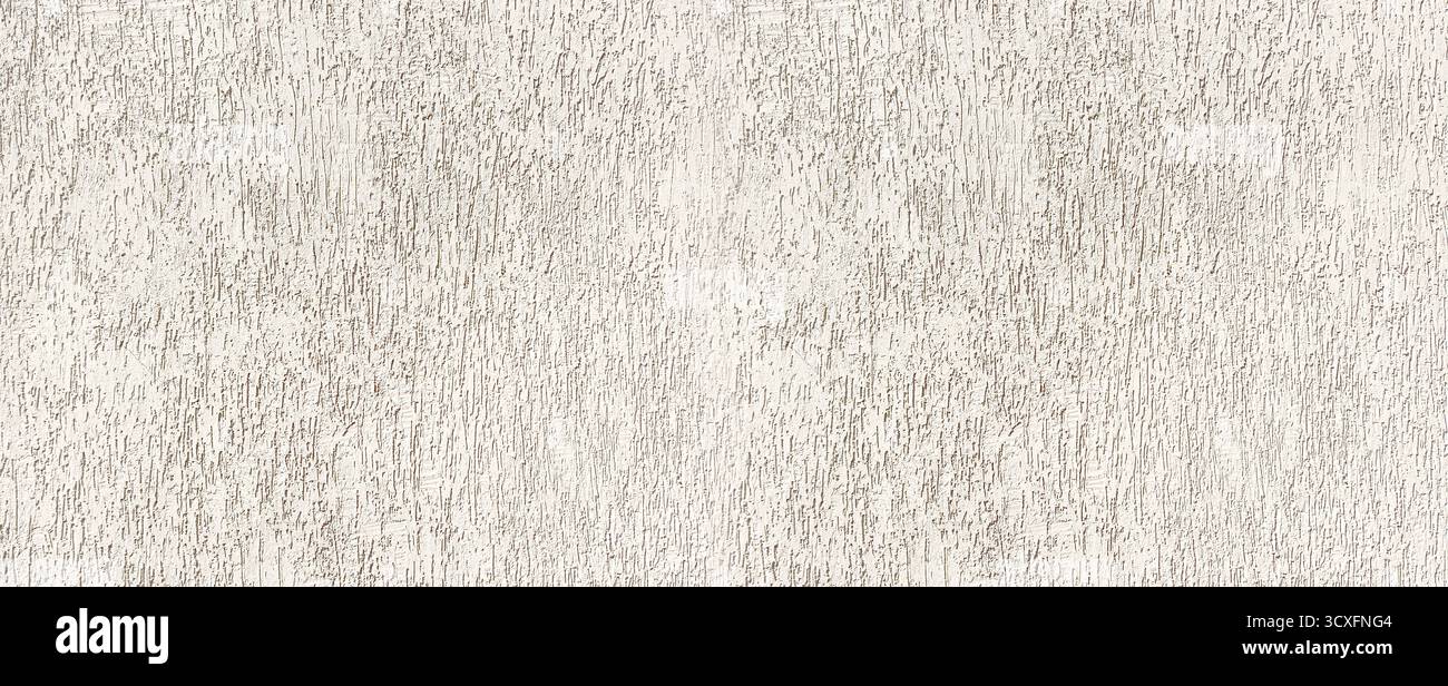 Stucco wall presenting a rough textured surface as a building background Stock Photo