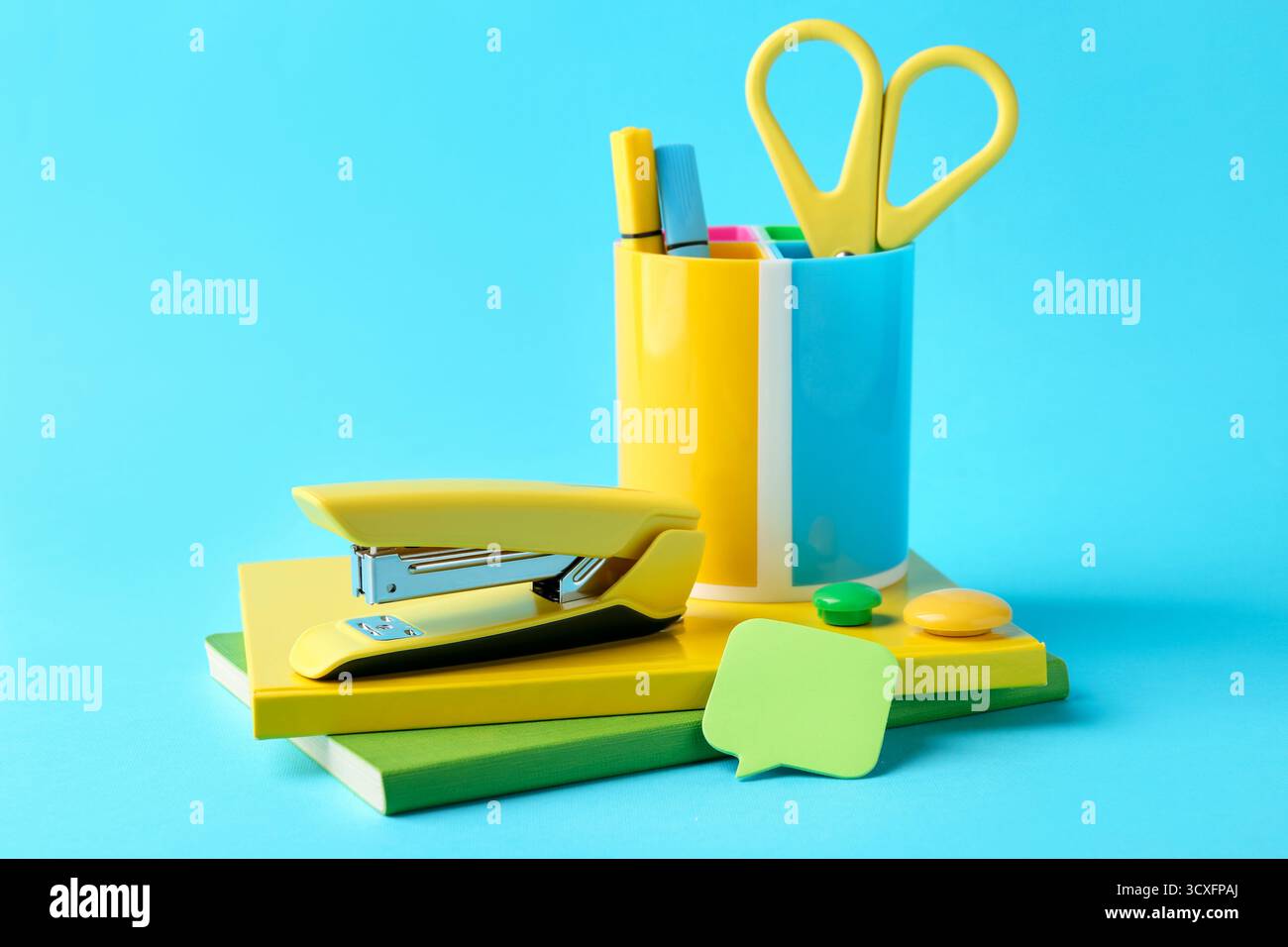 Stapler and other stationery on light blue background Stock Photo