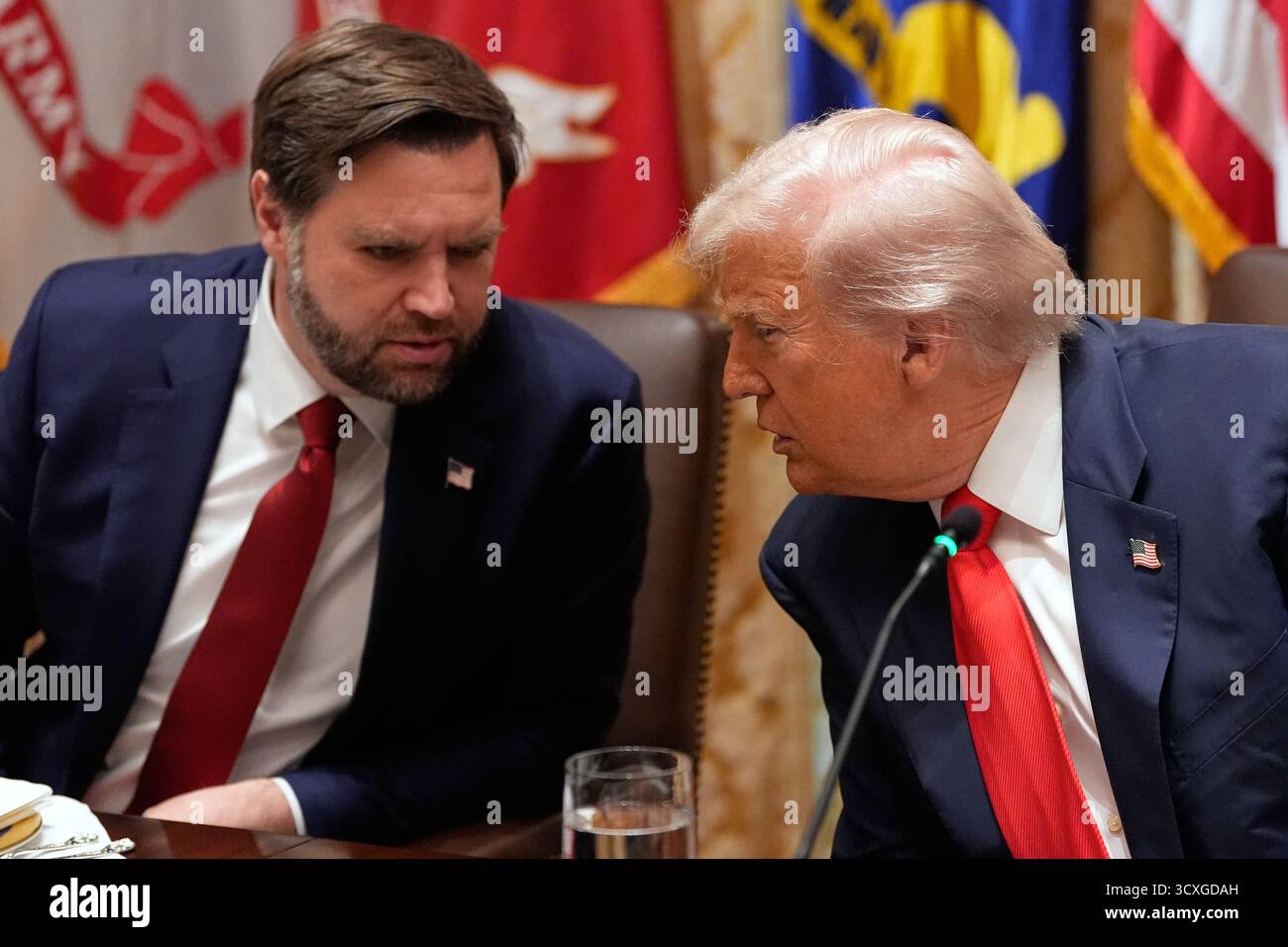 President Donald Trump listens to Vice President JD Vance during a ...