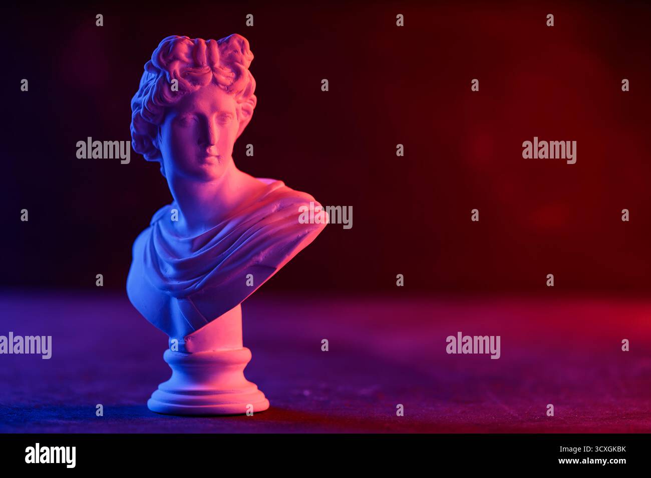 Decorative Plaster Head in Blue Red Gradient Light Installation Stock Photo