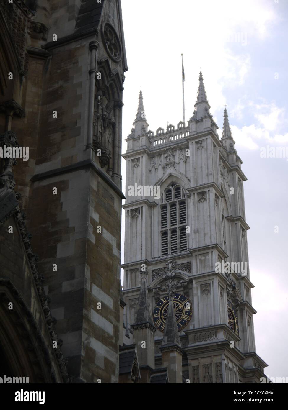 Gothic cathedral facade with ornate spires and clock tower against ...