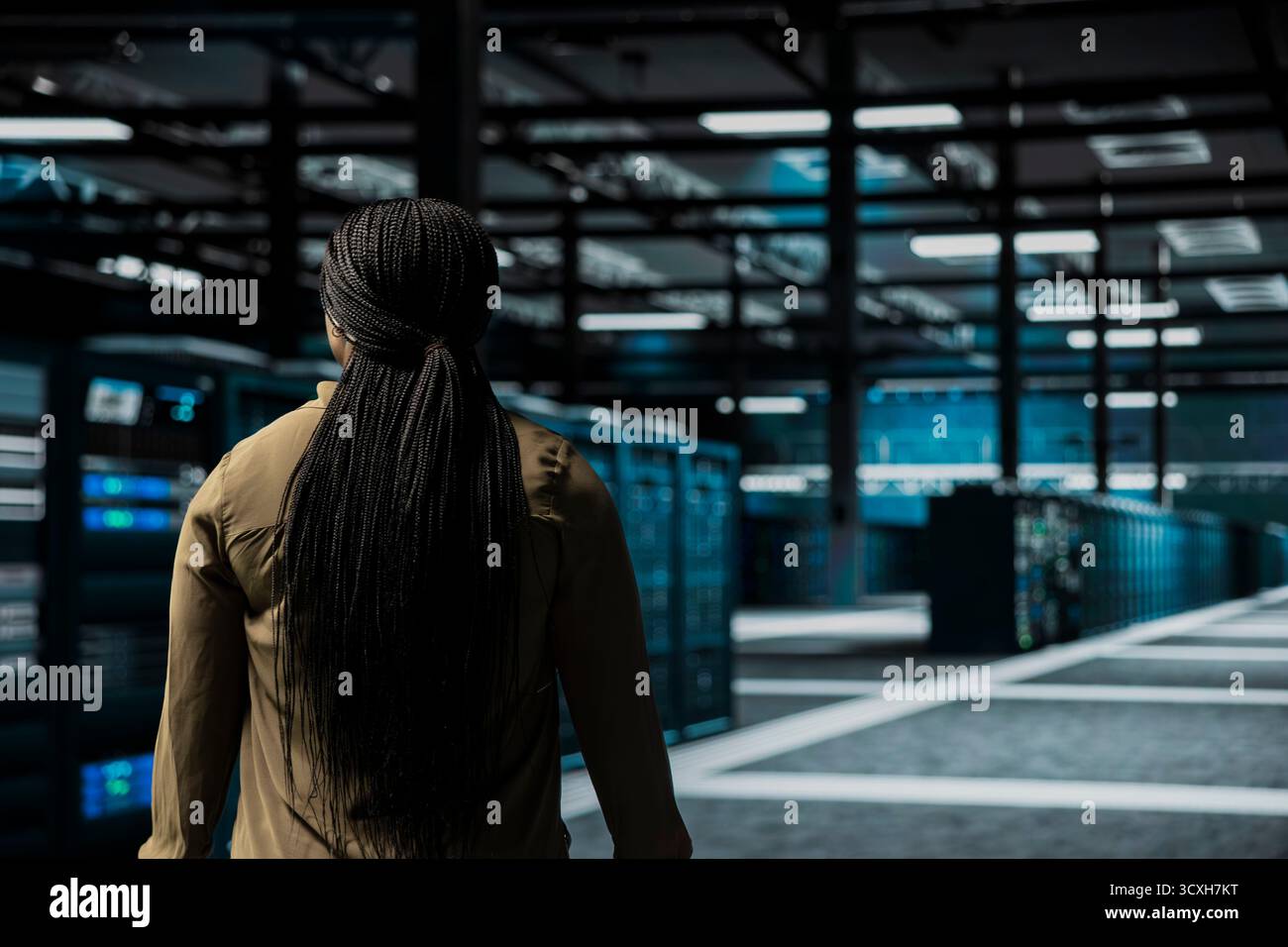 Software developer walking through server room rows lined with storage infrastructure rigs. IT worker inspecting high tech data center helping power internet services for business clients Stock Photo