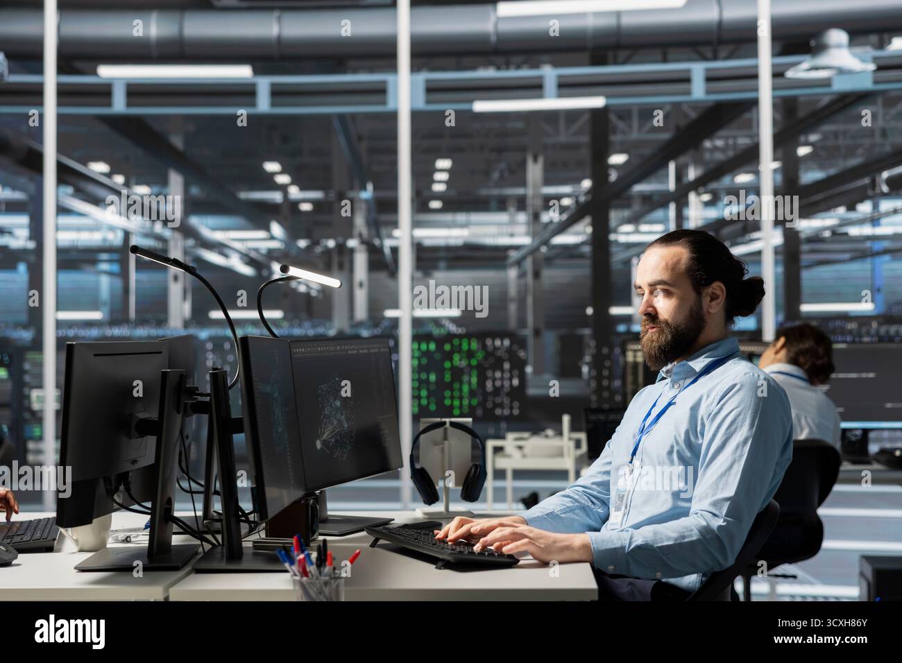 Data center admin running diagnostic scripts on computer, examining infrastructure. Server room IT expert using PC to evaluate performance metrics, running tests to maintain system stability Stock Photo