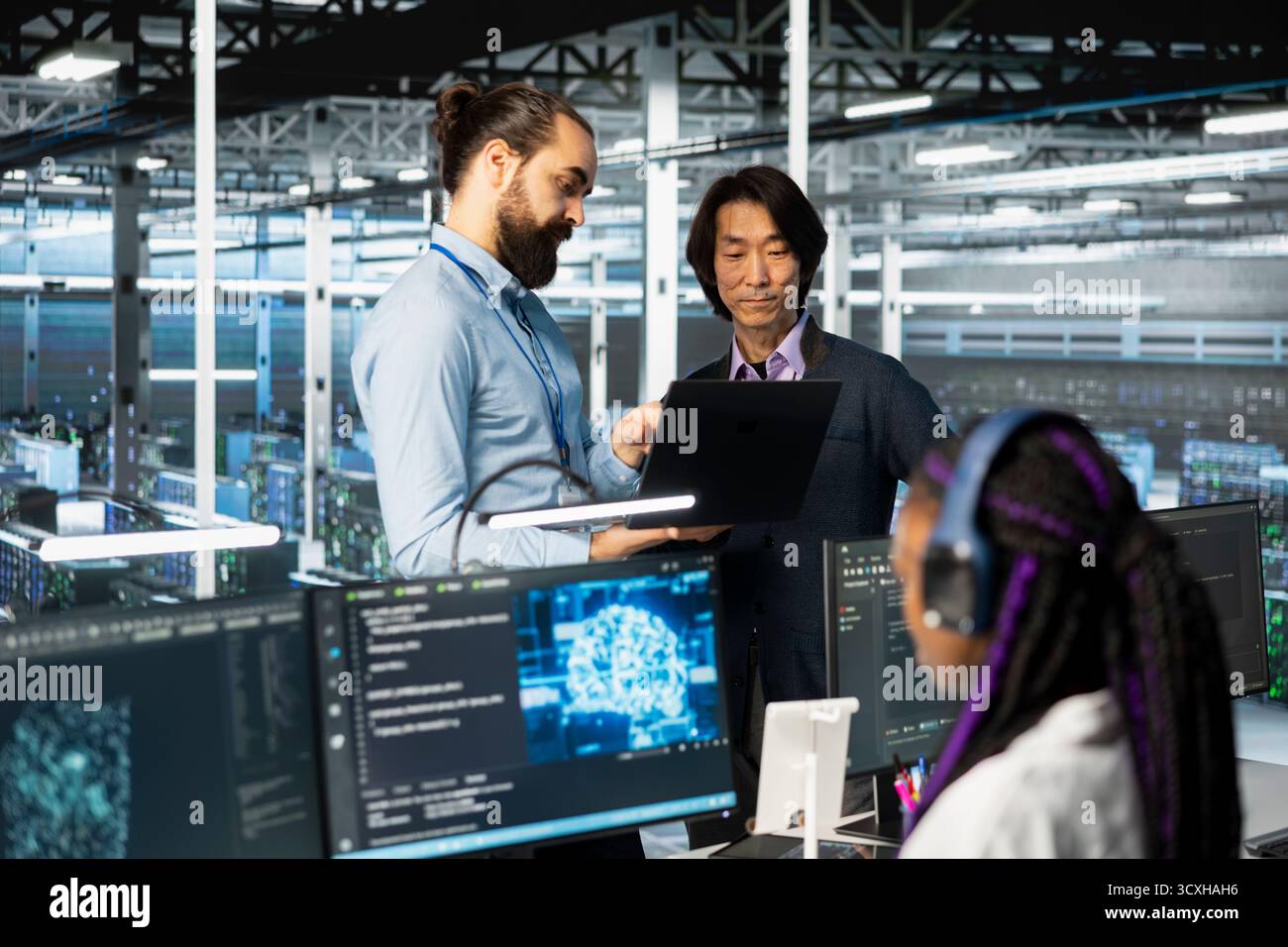Programmers working together, coding in data center, updating deep learning scripts. Asian man and coworker in server hub programming artificial intelligence algorithms, debugging equipment racks Stock Photo
