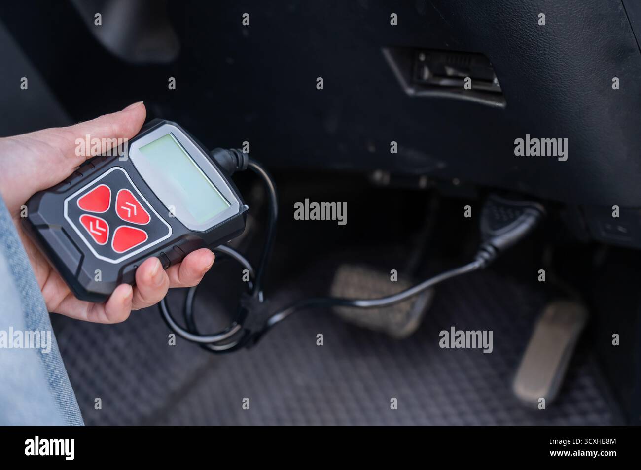 Woman using OBD2 diagnostic scanner.  Stock Photo