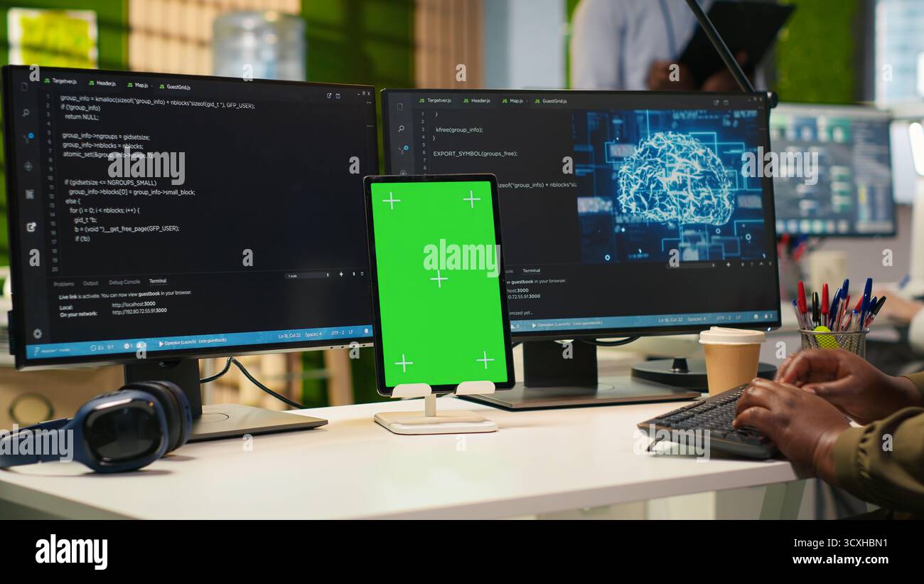 Admin using isolated screen tablet to code AI algorithms debugging software issues and improving system stability. Tech startup office worker using chroma key device, configuring settings, camera A Stock Photo