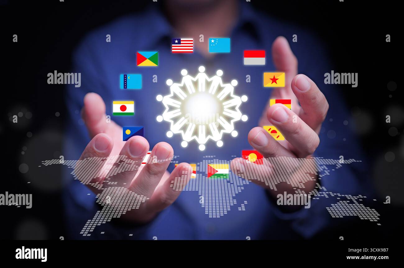 Hands holding world map with international flags and glowing network icon symbolizing teamwork, unity, and cooperation among global nations for busine Stock Photo