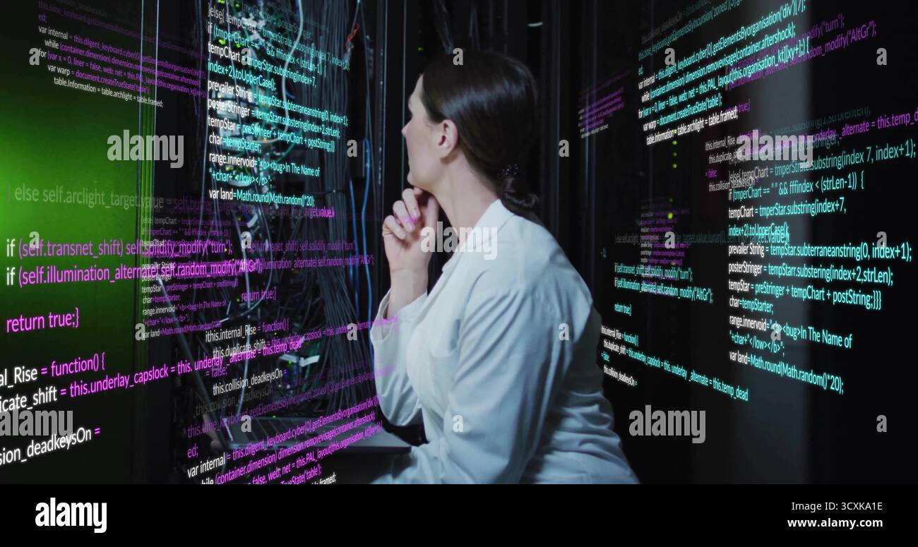Analyzing female specialist reviewing code in data center with display panels, server racks, cables Stock Photo