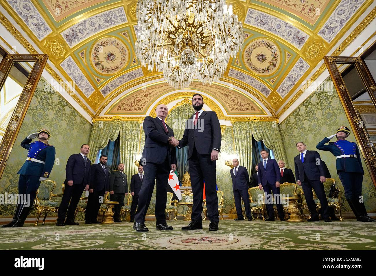 Russian President Vladimir Putin, left, and Syrian interim President Ahmad al-Sharaa shake hands during their meeting at the Grand Kremlin Palace in Moscow, Russia, Wednesday, Oct. 15, 2025. (AP Photo/Alexander Zemlianichenko, Pool) Stock Photo