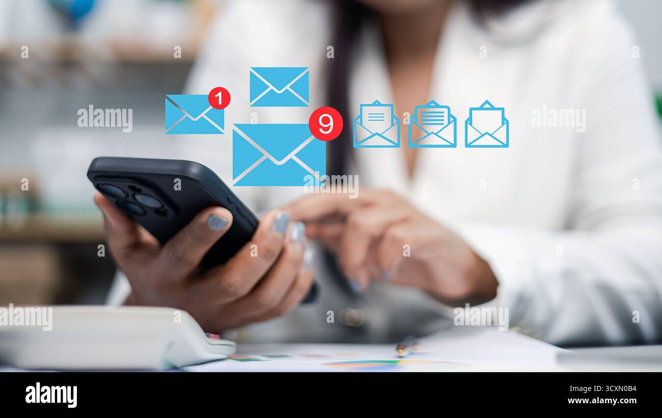 Close-up of businesswoman using smartphone with email notification icons, concept of digital communication, online messaging, and business technology Stock Photo