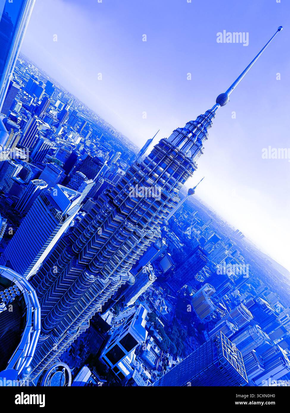 Aerial view of Petronas Twin Towers in a blue light filter showcasing the Kuala Lumpur city skyline - Smartphone Captured Stock Image