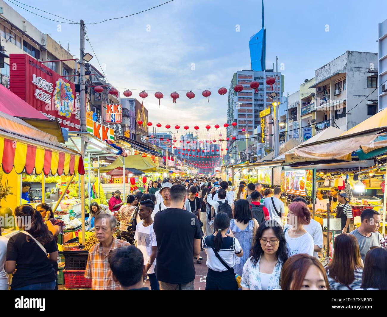alan Jalor food street market in kuala lumpur malaysia with people shopping at outdoor stalls beneath decorative red lanterns during the evening - Smartphone Captured Stock Image