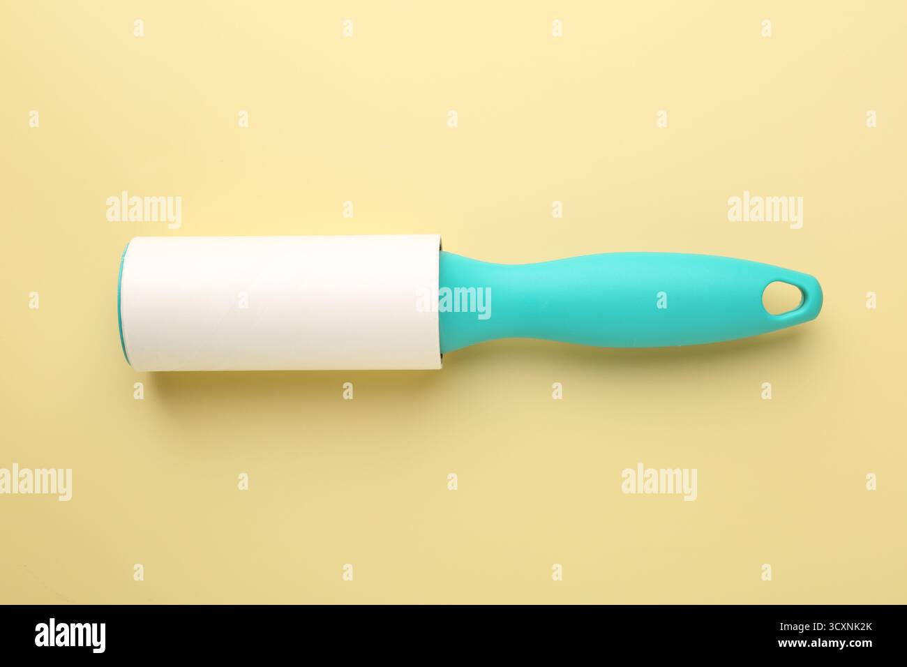 One lint roller on yellow background, top view Stock Photo