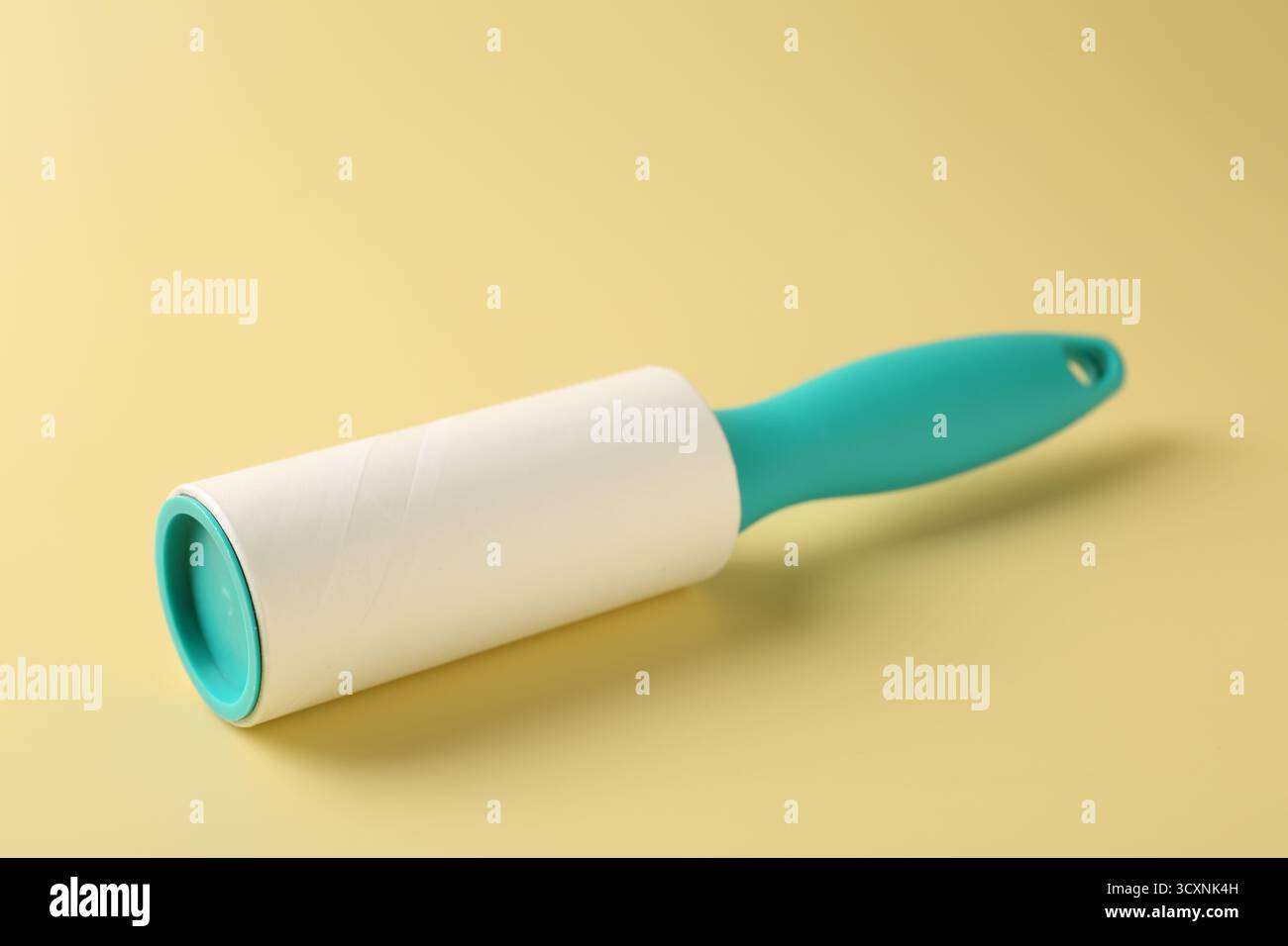 One lint roller on yellow background, closeup Stock Photo