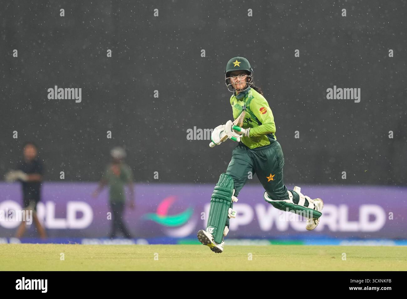 Pakistan's Muneeba Ali Siddiqui runs to pavilion as it rains during the ...