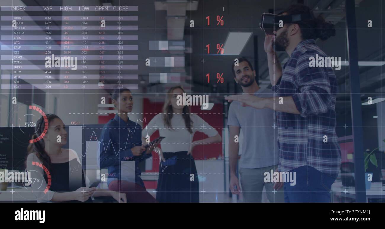 Gesturing Middle Eastern man with VR headset presenting charts in open-plan office, copy space Stock Photo