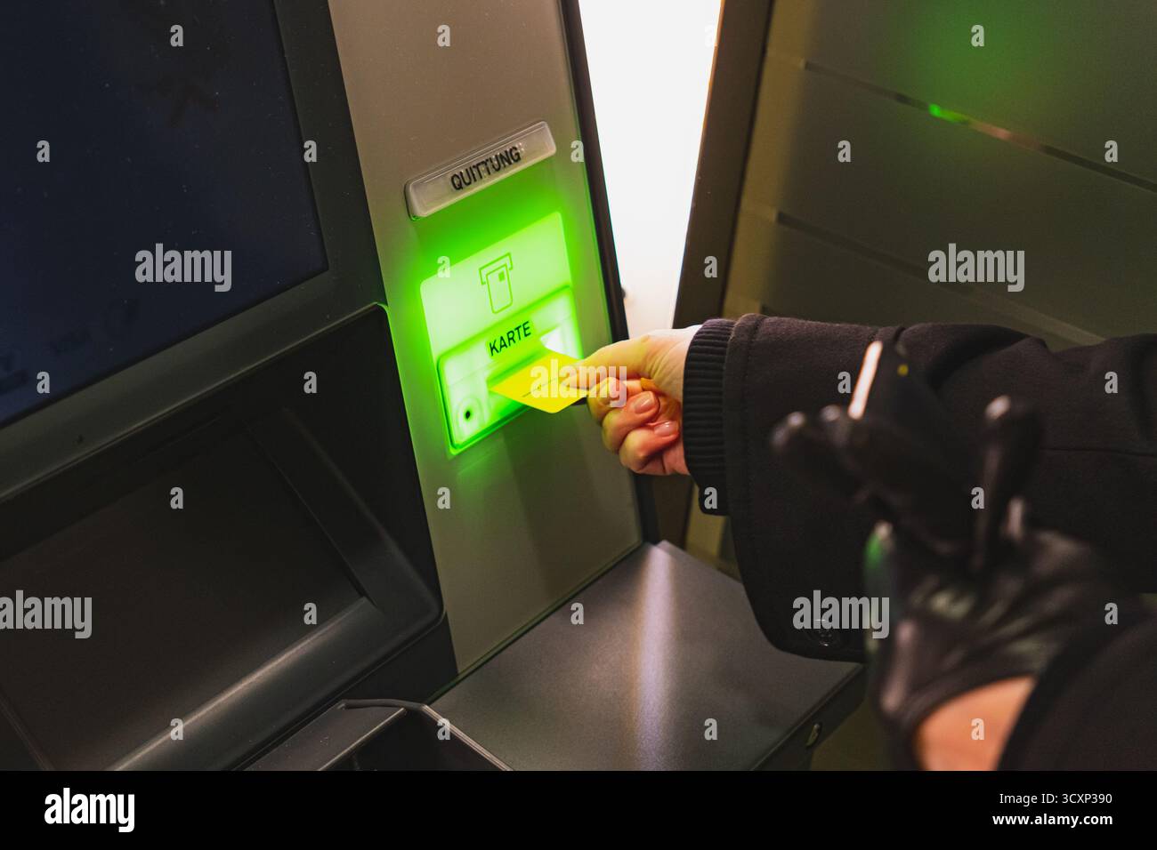 Client inserting credit card into ATM banking machine Stock Photo