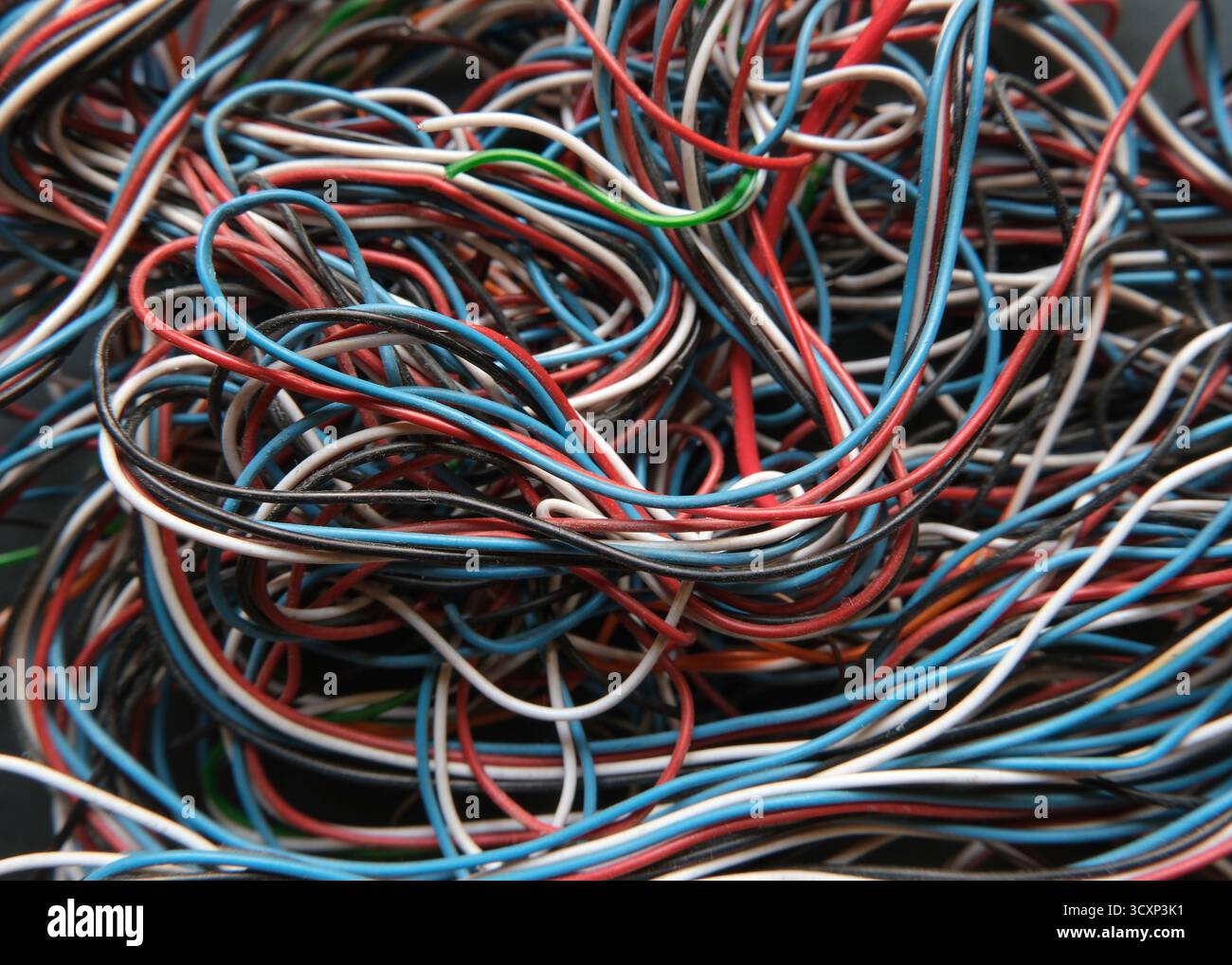 Chaotic cables on a black background. Colorful abstract thin wires texture. Stock Photo