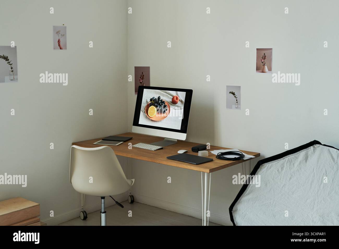 Modern Minimalist Workspace Featuring Desktop Computer Displaying Fruit Still Life Stock Photo