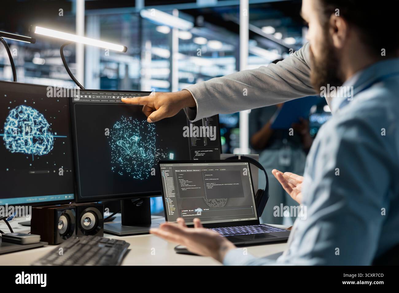 Team of admins using computer in data center office, integrating AI driven automation tools. Server farm IT specialists working together, using artificial intelligence deep learning models Stock Photo