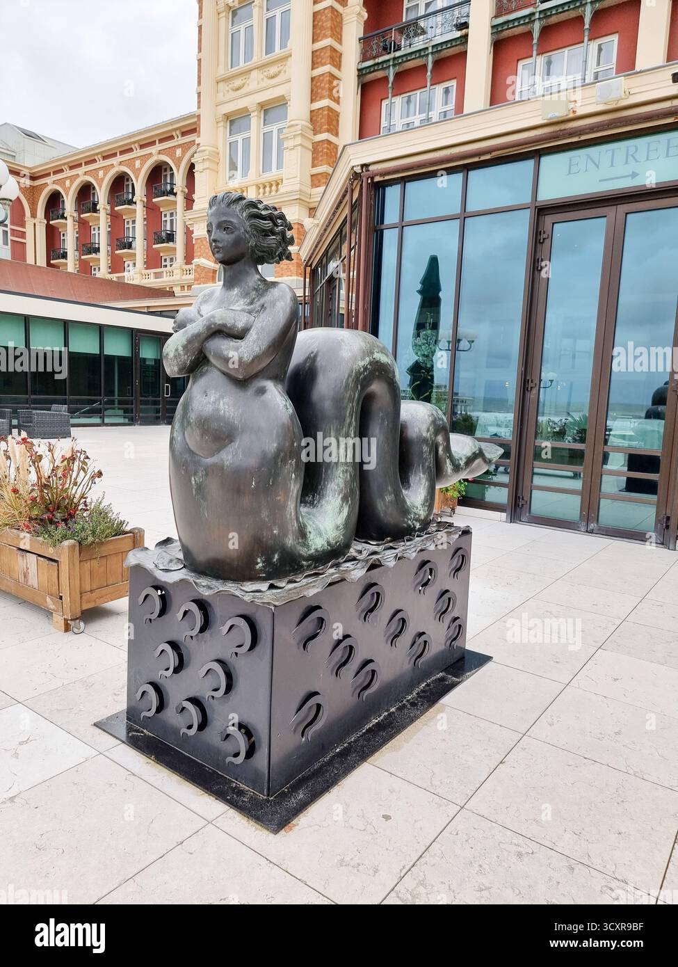 Bronze sculpture of female figure with long, wavy tail, on boulevard near the Kurhaus in Scheveningen, The Hague, Netherlands - Smartphone Captured Stock Image