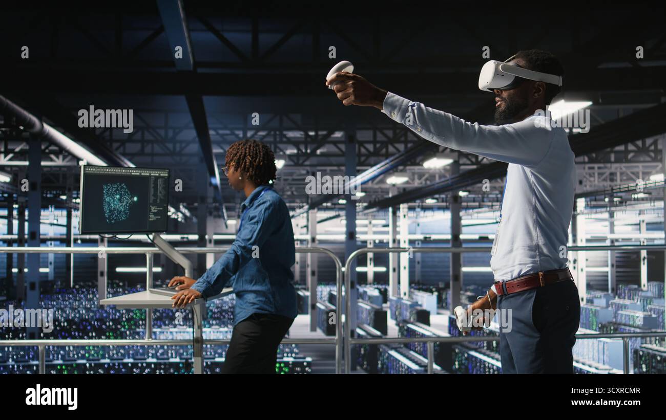 Engineer using VR headset in data center to update server tech, configuring equipment using software tools. Server hub employee reviewing hardware analytics using virtual reality, Stock Photo
