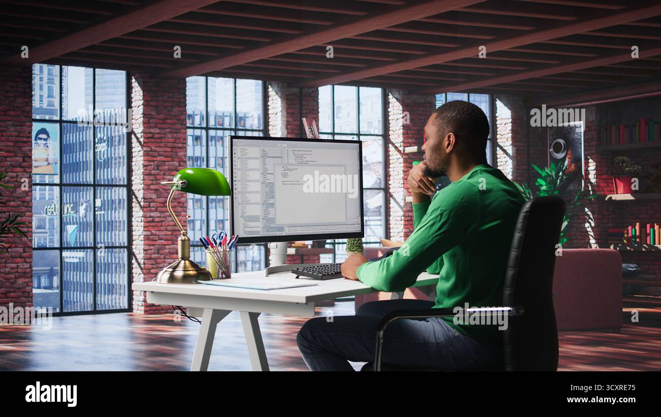 Black IT developer at PC coding and creating an app software, implementing algorithms to fix errors. Engineer in his loft working with code language, optimizing app performance. Camera A. Stock Photo