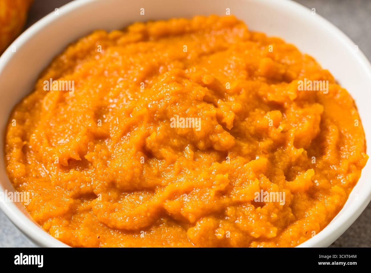 Raw Organic Cooked Pumpkin Puree in a Bowl Stock Photo