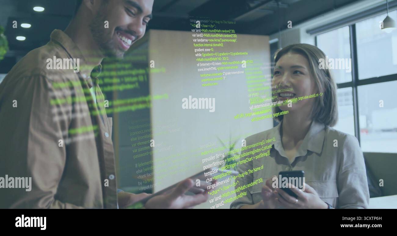 Discussing code on glass partition in office, two developers gesturing with smartphone beside plant Stock Photo