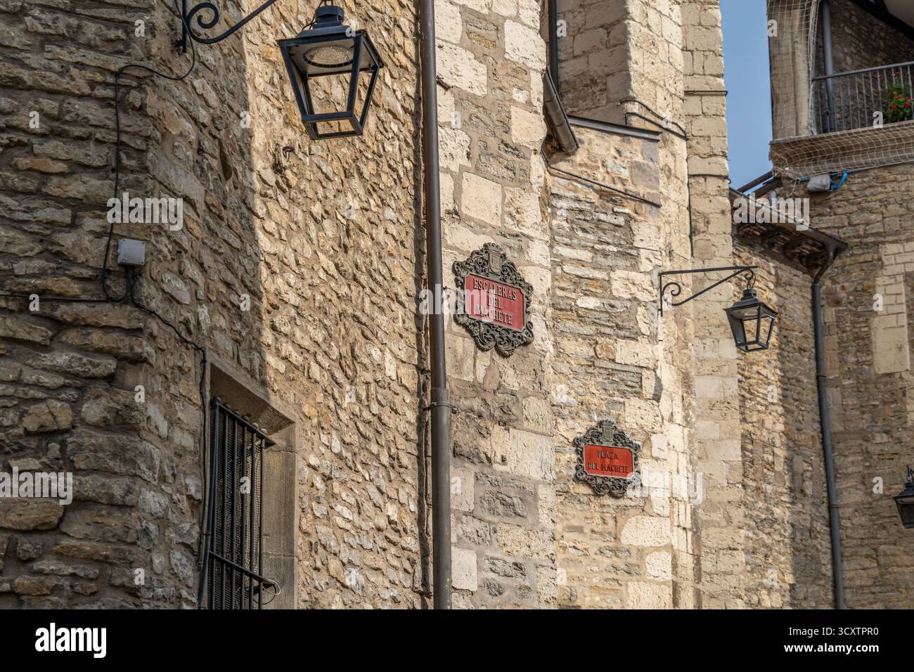 Traditional ornate metal street name signs with decorative frames on medieval stone wall in Vitoria-Gasteiz old town, Basque Country, Spain. Historic Stock Photo