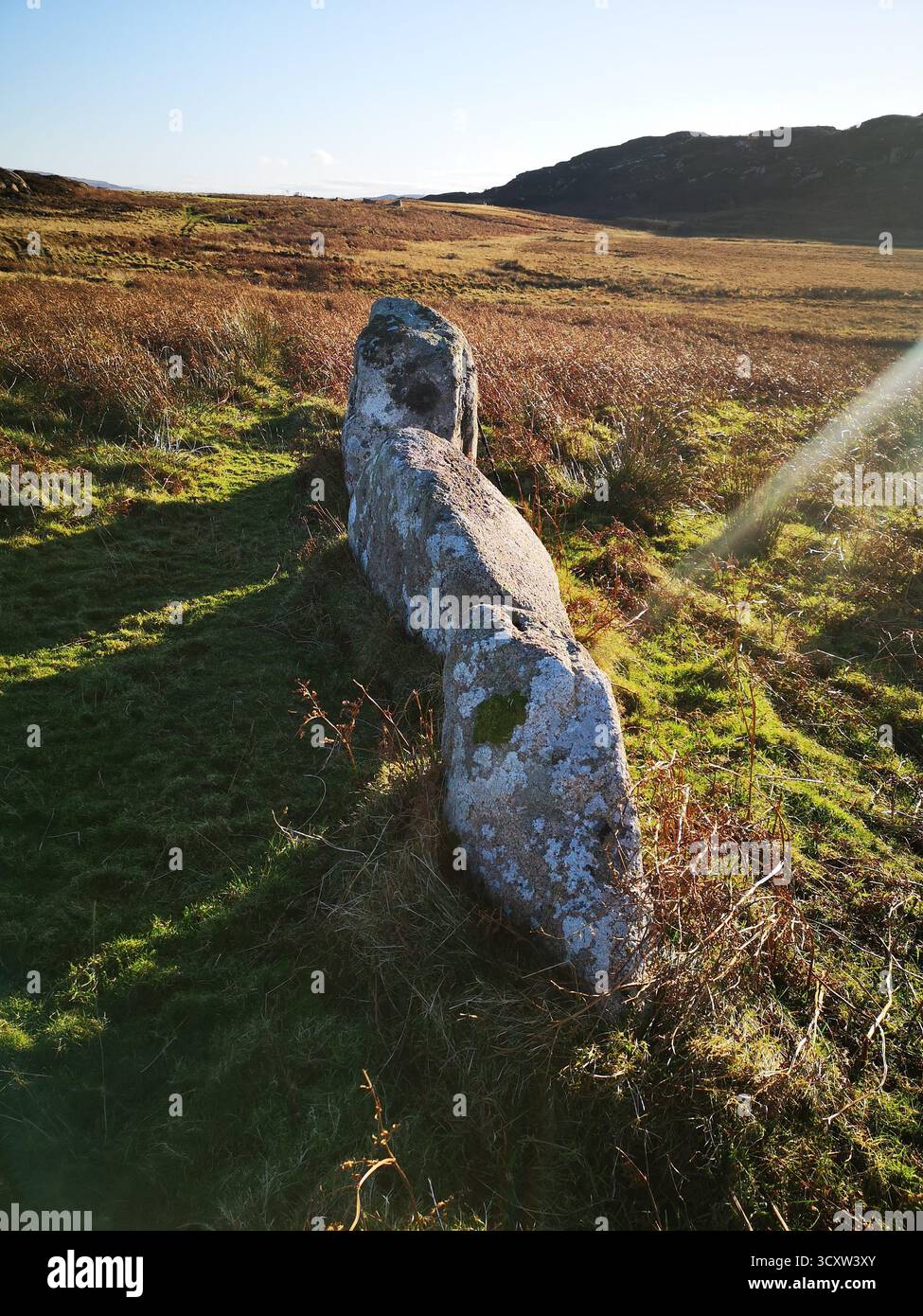 Flash of light strikes the Father, Son & Holy Ghost stones at Braighchreaich abandoned village near Kintra, Ross of Mull –stones used for rituals. - Smartphone Captured Stock Image