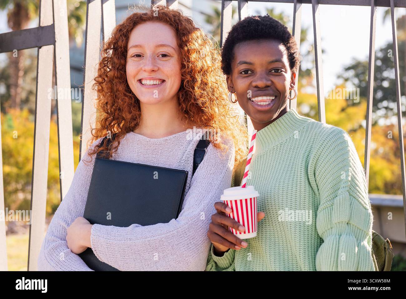 two young students smiling happy looking at camera Stock Photo