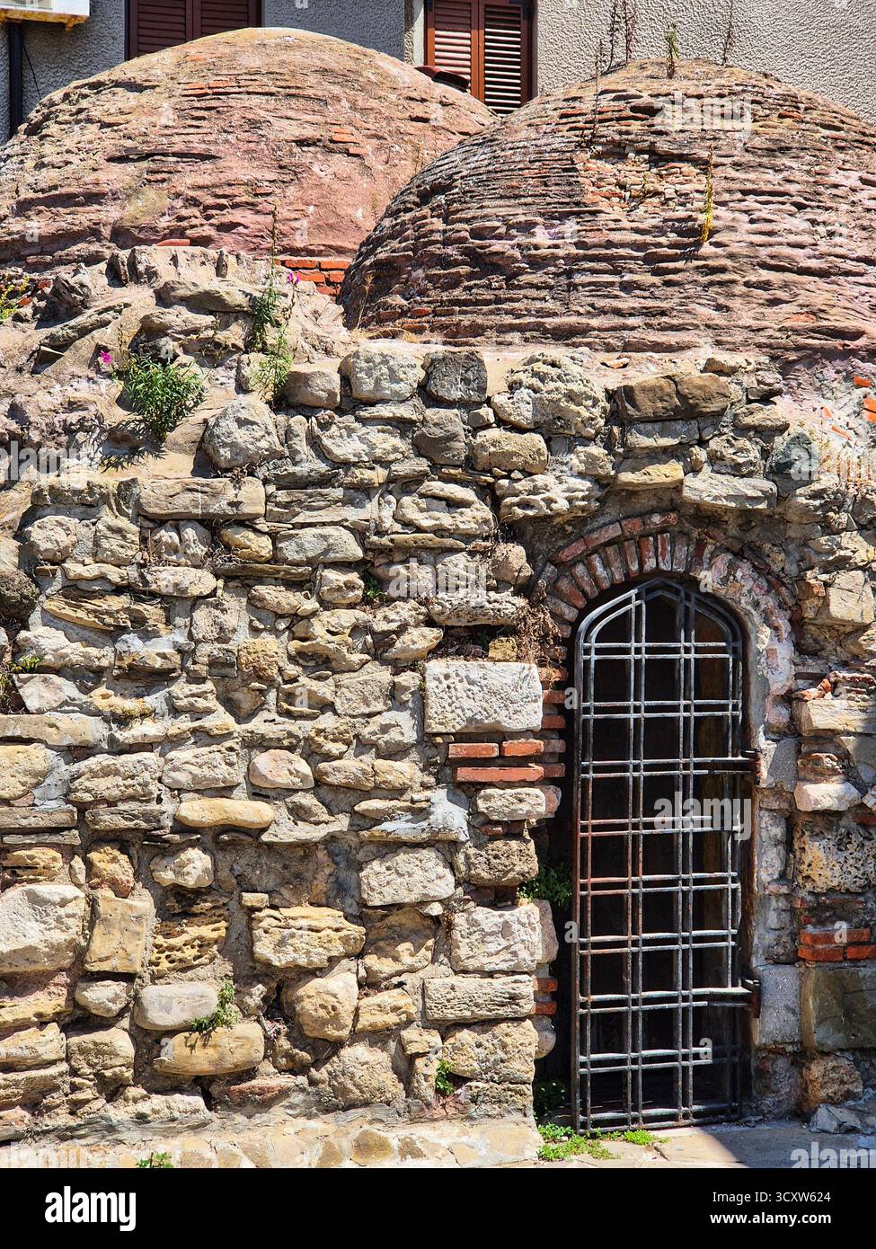 ancient stone wall with arched window. medieval architecture detail. historic building facade - Smartphone Captured Stock Image