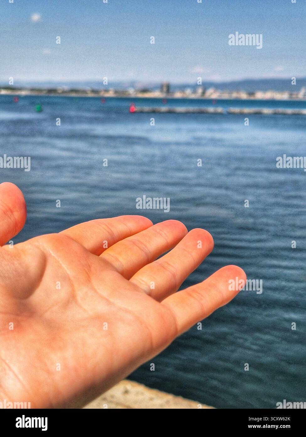 hand pointing at the sea panorama - Smartphone Captured Stock Image