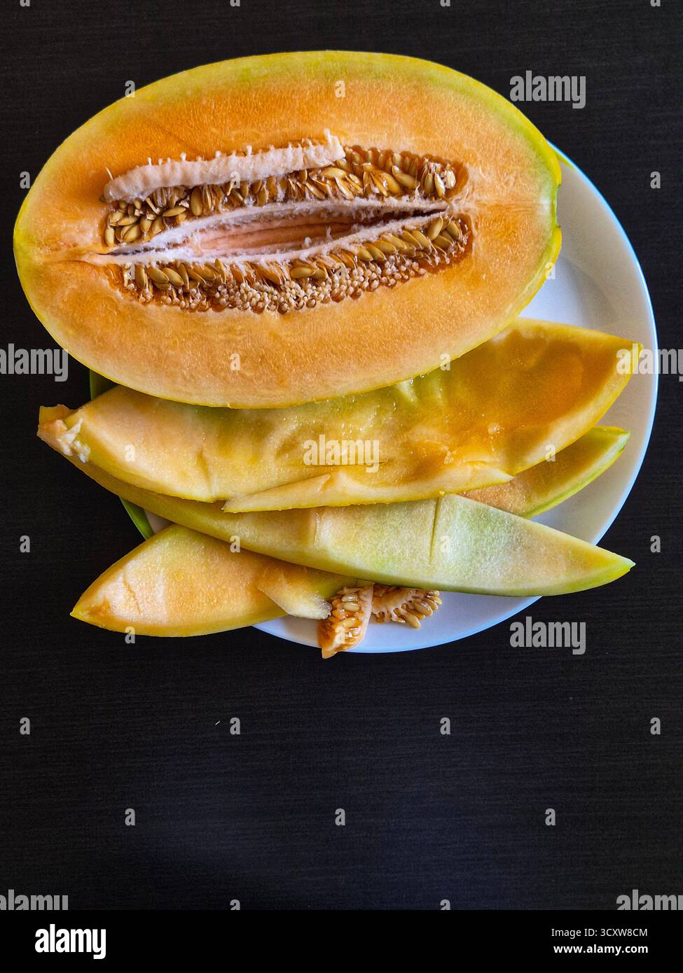 sliced yellow melon. melon seeds - Smartphone Captured Stock Image