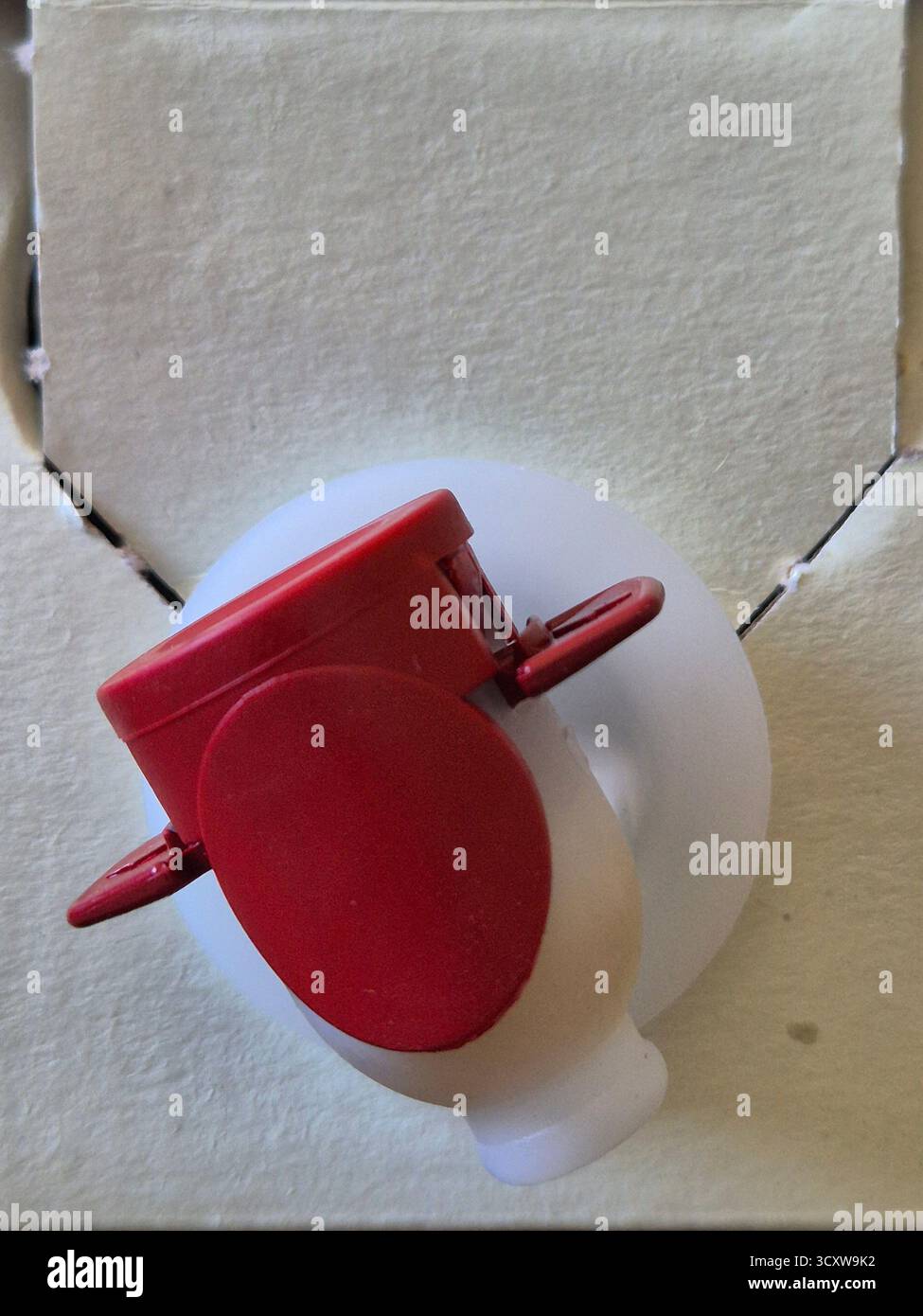 red plastic tap for pouring wine from plastic packaging (bag-in-box) - Smartphone Captured Stock Image