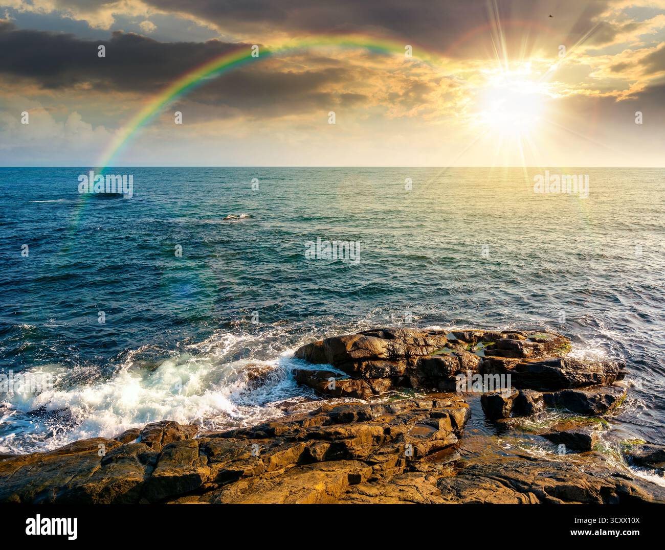 sea coast with rocks and boulders at sunset. calm summer vacation background at the seashore. wonderful scene for relax and leisure at the seaside in Stock Photo