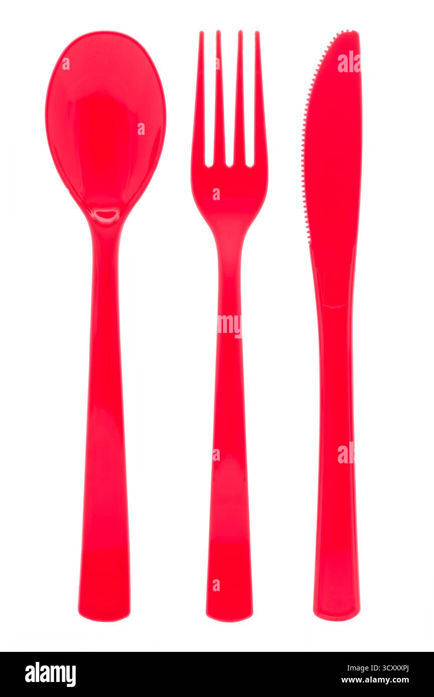 Red plastic cutlery on white background Stock Photo