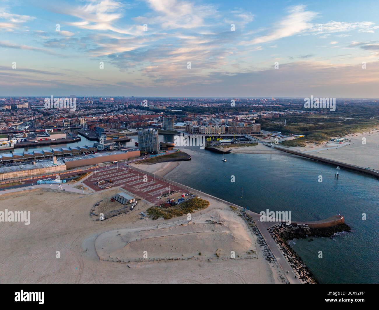 Aerial view of coastal city harbor with piers and breakwaters, dense ...