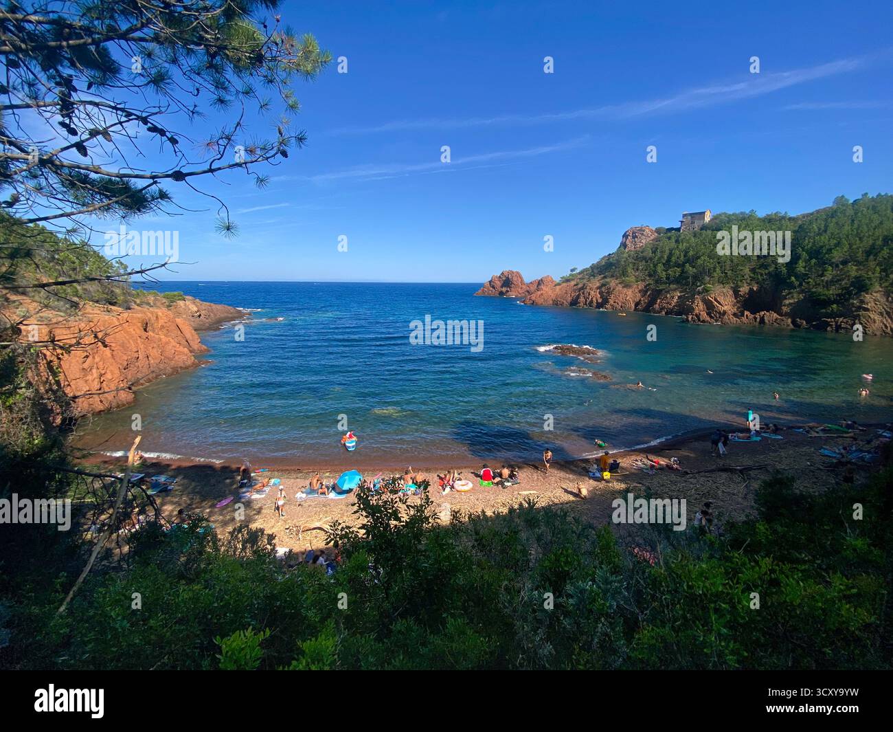 Scenic Cove Beach with Swimmers and Rocky Coastline Stock Photo - Alamy