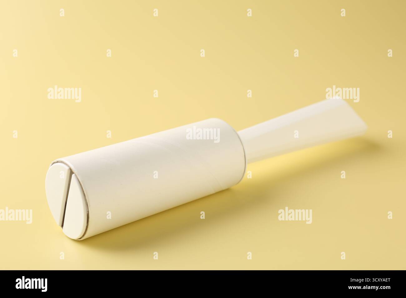 One lint roller on yellow background, closeup Stock Photo