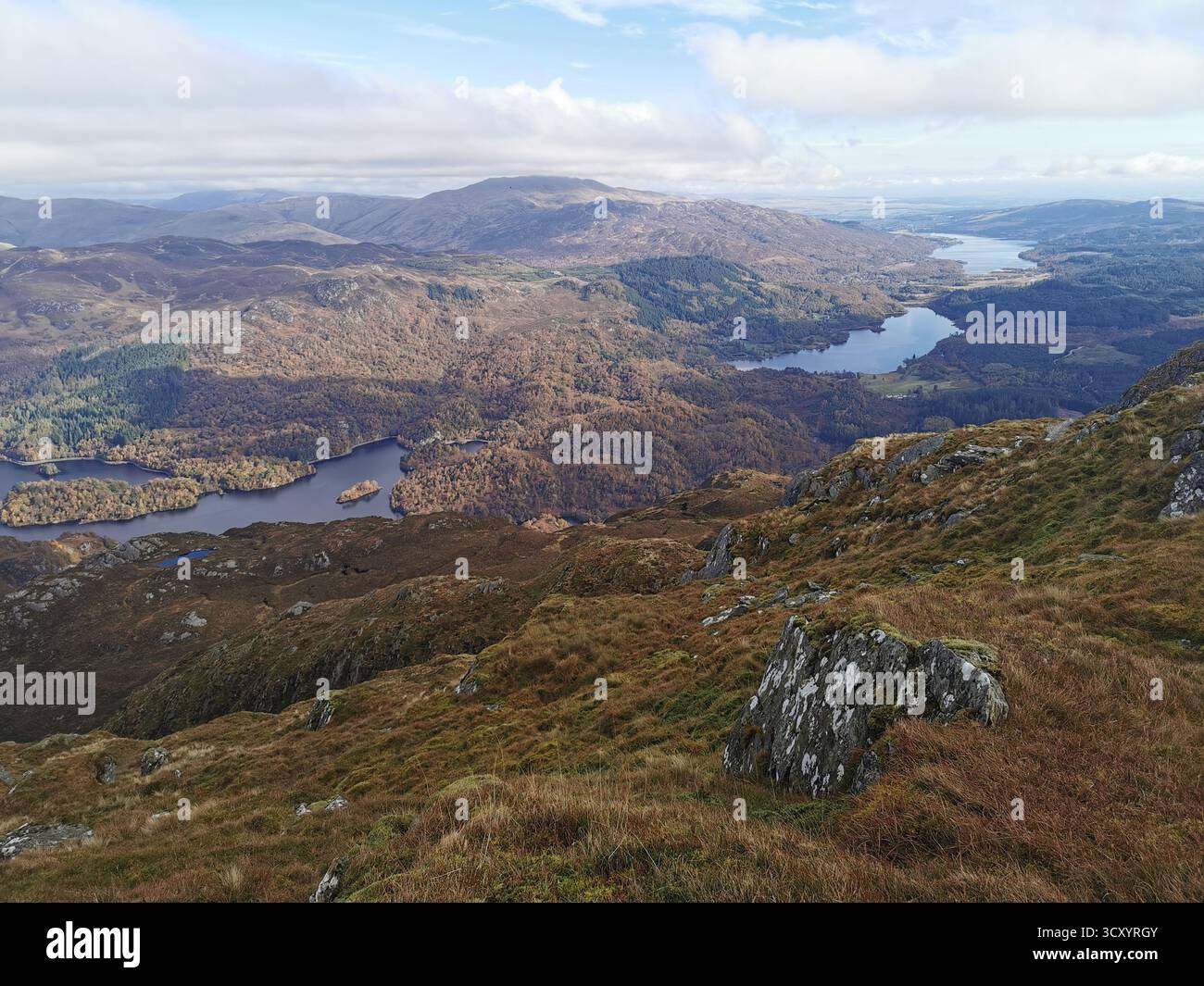 Panoramic view from Ben Venue summit over Loch Venacher, Loch Achray & Loch Katrine in Scotland’s Trossachs National Park – scenic Highlands landscape - Smartphone Captured Stock Image