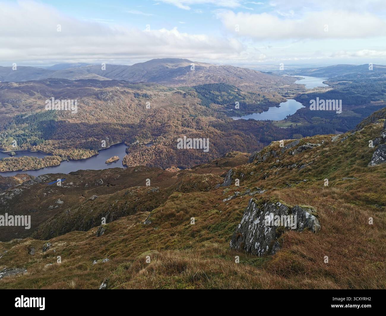 Panoramic view from Ben Venue summit over Loch Venacher, Loch Achray & Loch Katrine in Scotland’s Trossachs National Park – scenic Highlands landscape - Smartphone Captured Stock Image