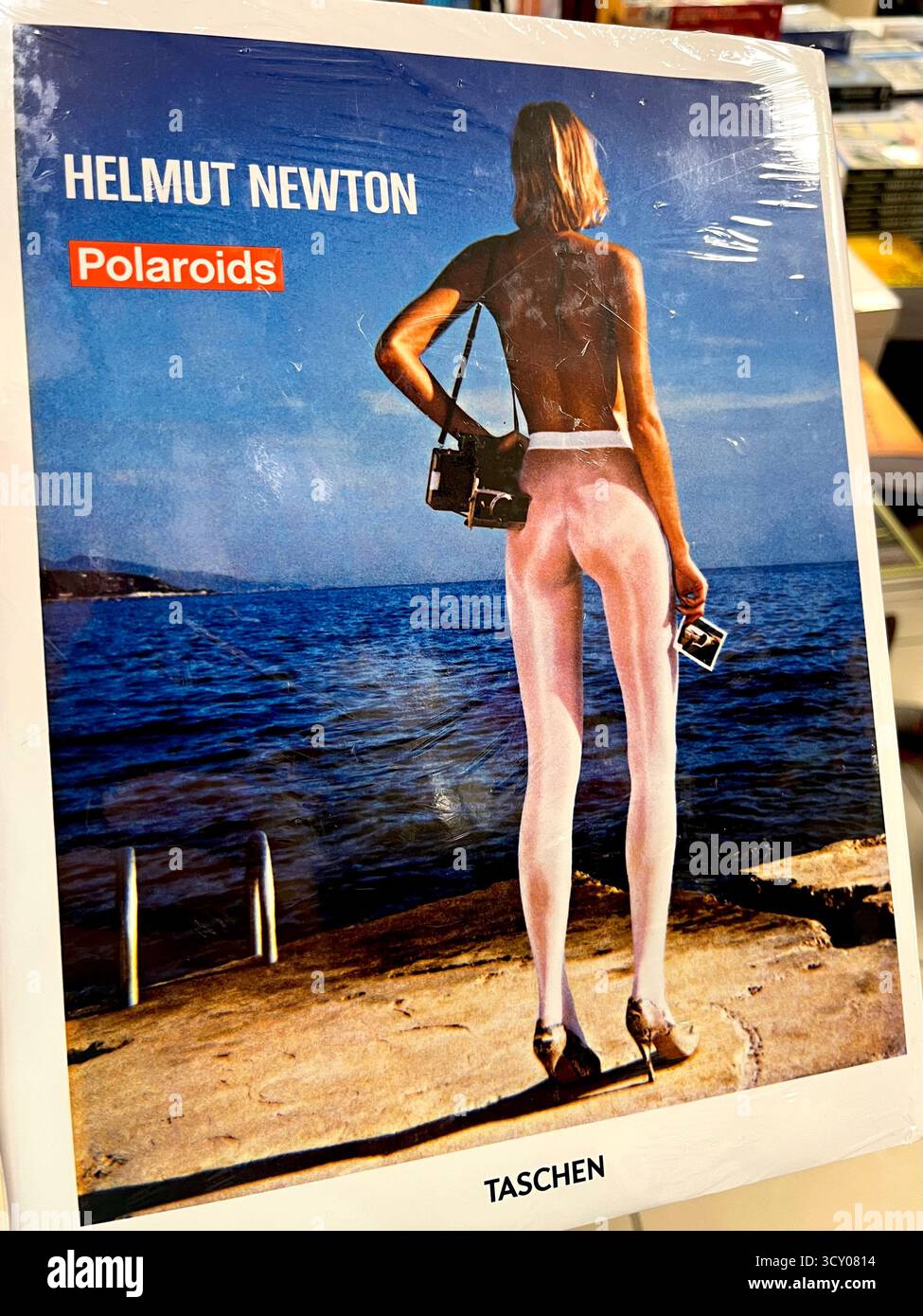 Helmut Newton Polaroids book front cover displayed in a bookstore or bookshop - Smartphone Captured Stock Image