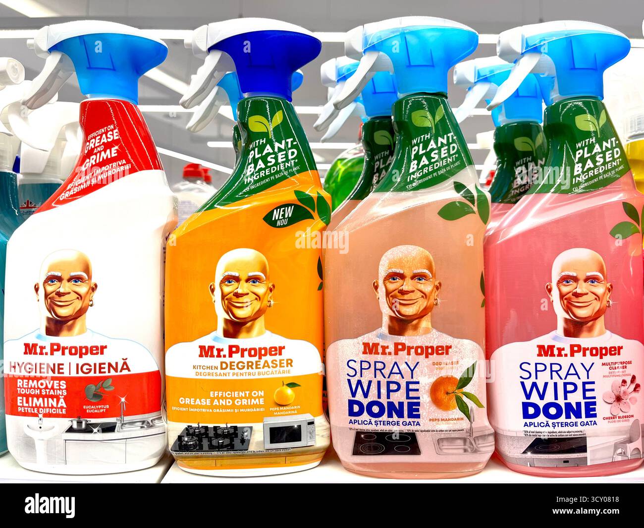 Various Mr. Proper cleaning products spray bottles displayed on store shelf - Smartphone Captured Stock Image