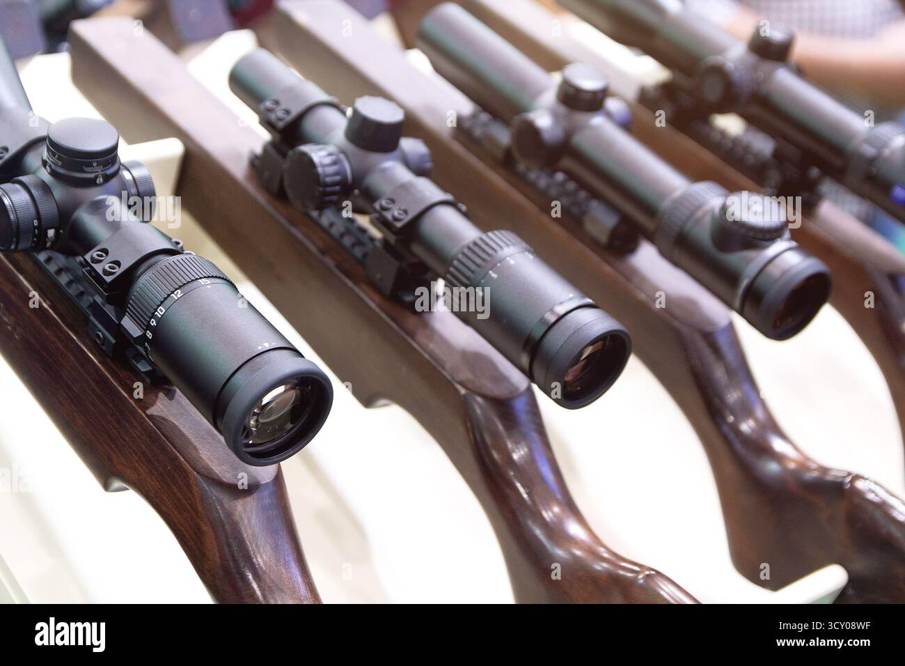 Telescopic sights on hunting rifles for sale in the store. Sale Stock Photo