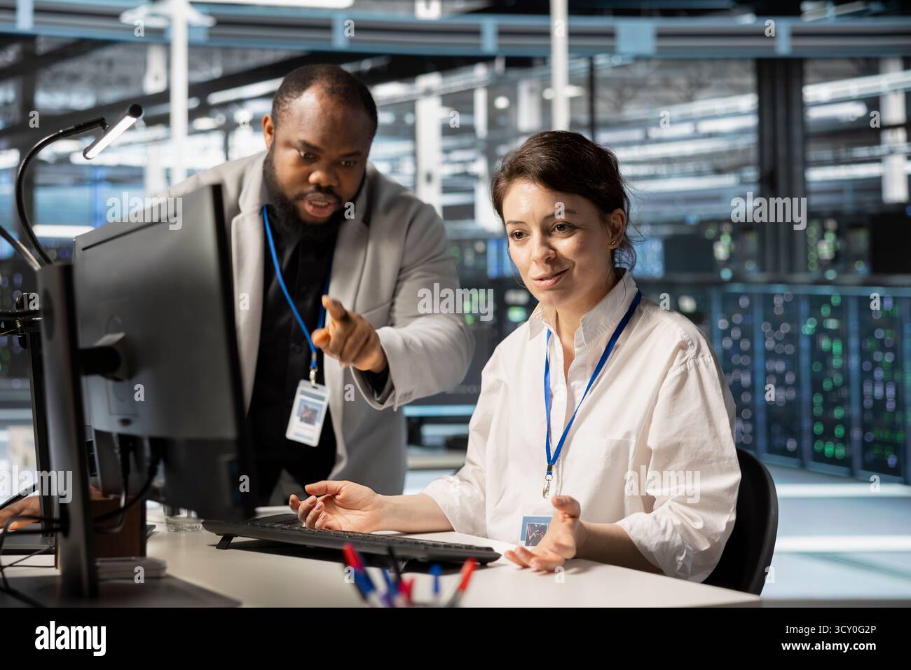 Supervisor overseeing data center updating hi-res stock photography and ...