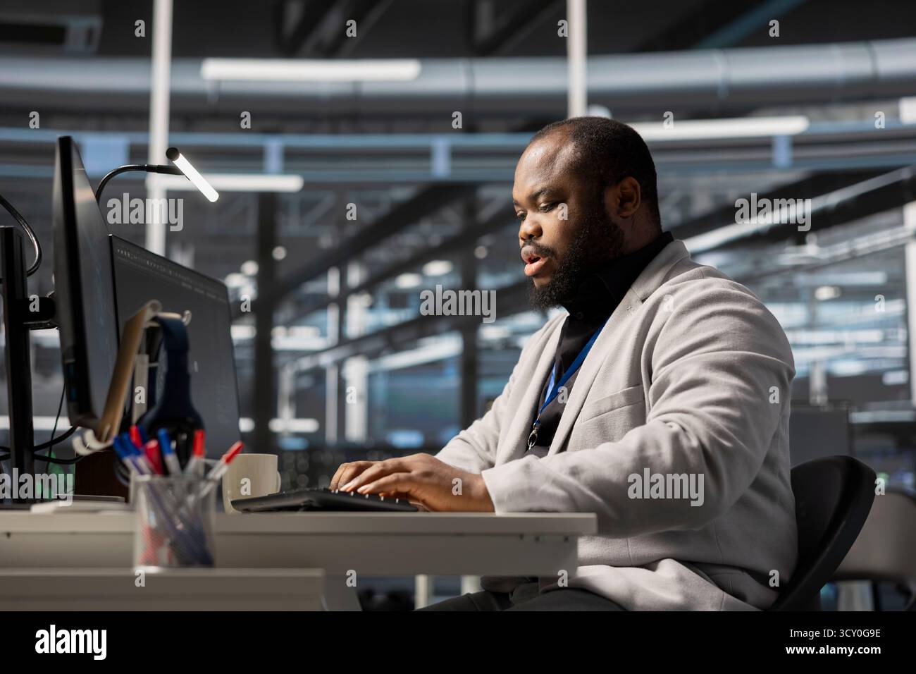Data center system administrator running diagnostic scripts, examining infrastructure. Man working in server hub using PC to evaluate performance metrics, running tests to maintain system stability Stock Photo